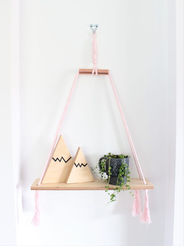 Baby pink macrame cord with birch plywood shelf and copper accent with two hand painted mountain shelfies and a string of peals in a vintage mug