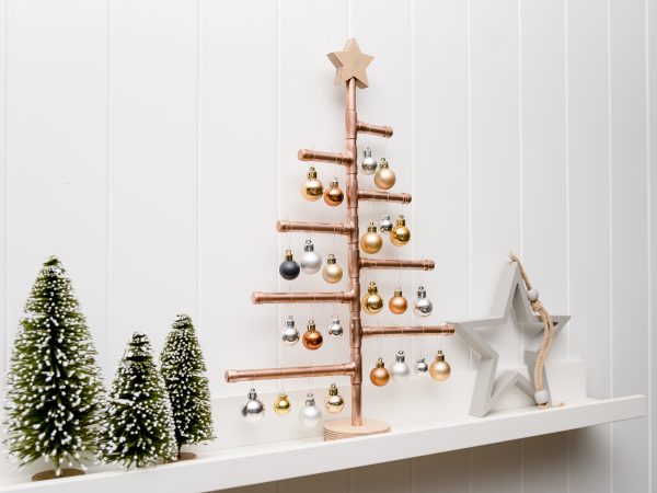 Copper Christmas Tree with wooden star decorated with baubles