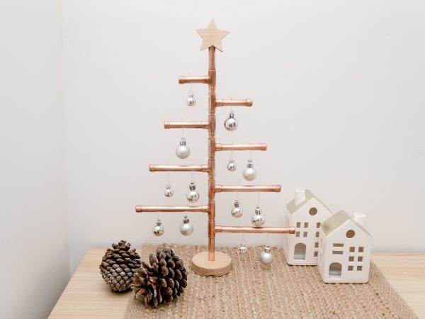 Copper Christmas Tree with wooden star decorated with baubles